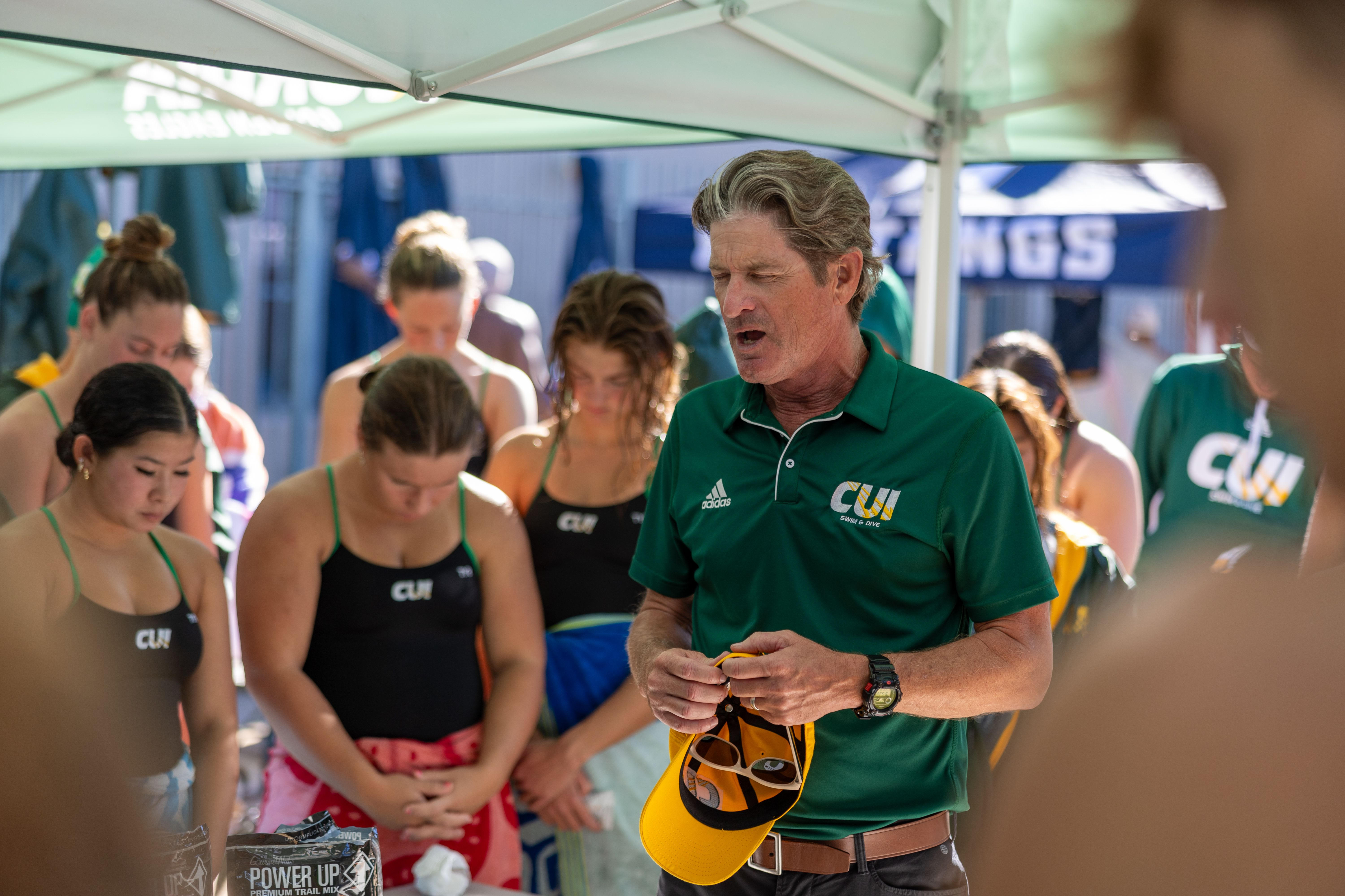 Head Coach, Bert Bergen, praying for the team 